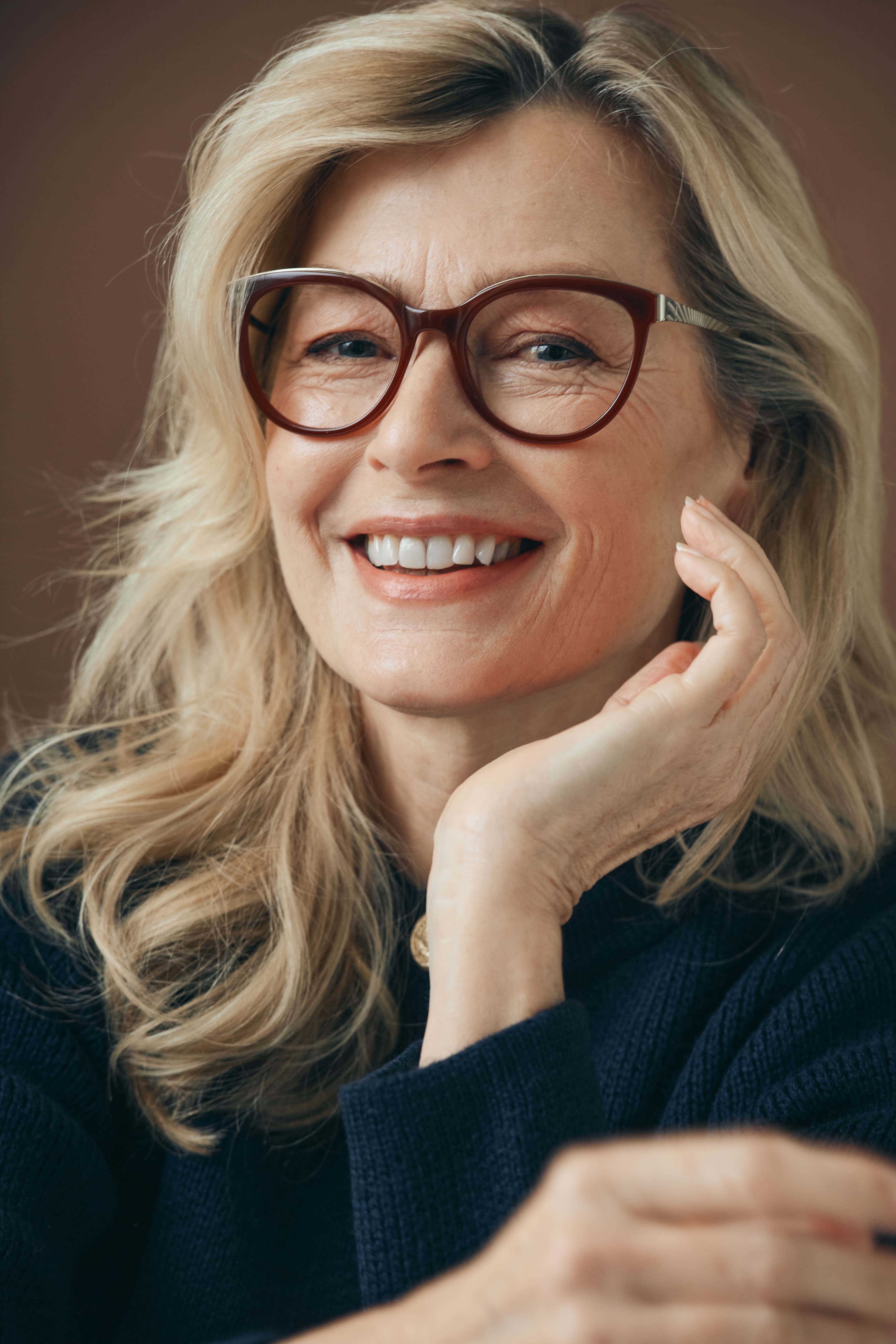 Mann mit goldener doppelsteg korrektionsbrille und beigen anzug